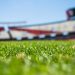 green grass across beige red open sports stadium during daytime